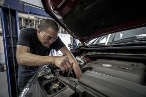 Man carrying out pre-test checks on his car